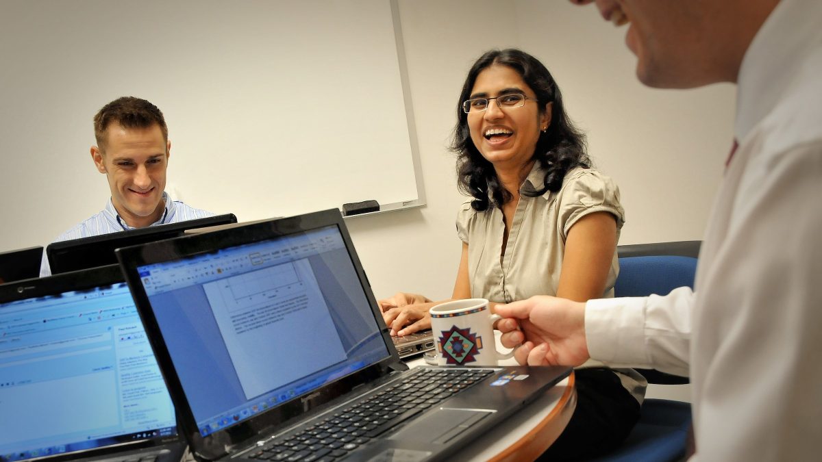 Computer scientists talking in study room